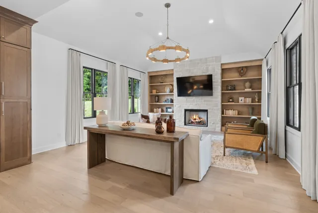 a bedroom with a bed mirror and a window