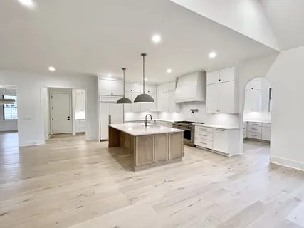 a spacious bathroom with a double vanity sink a mirror and shower