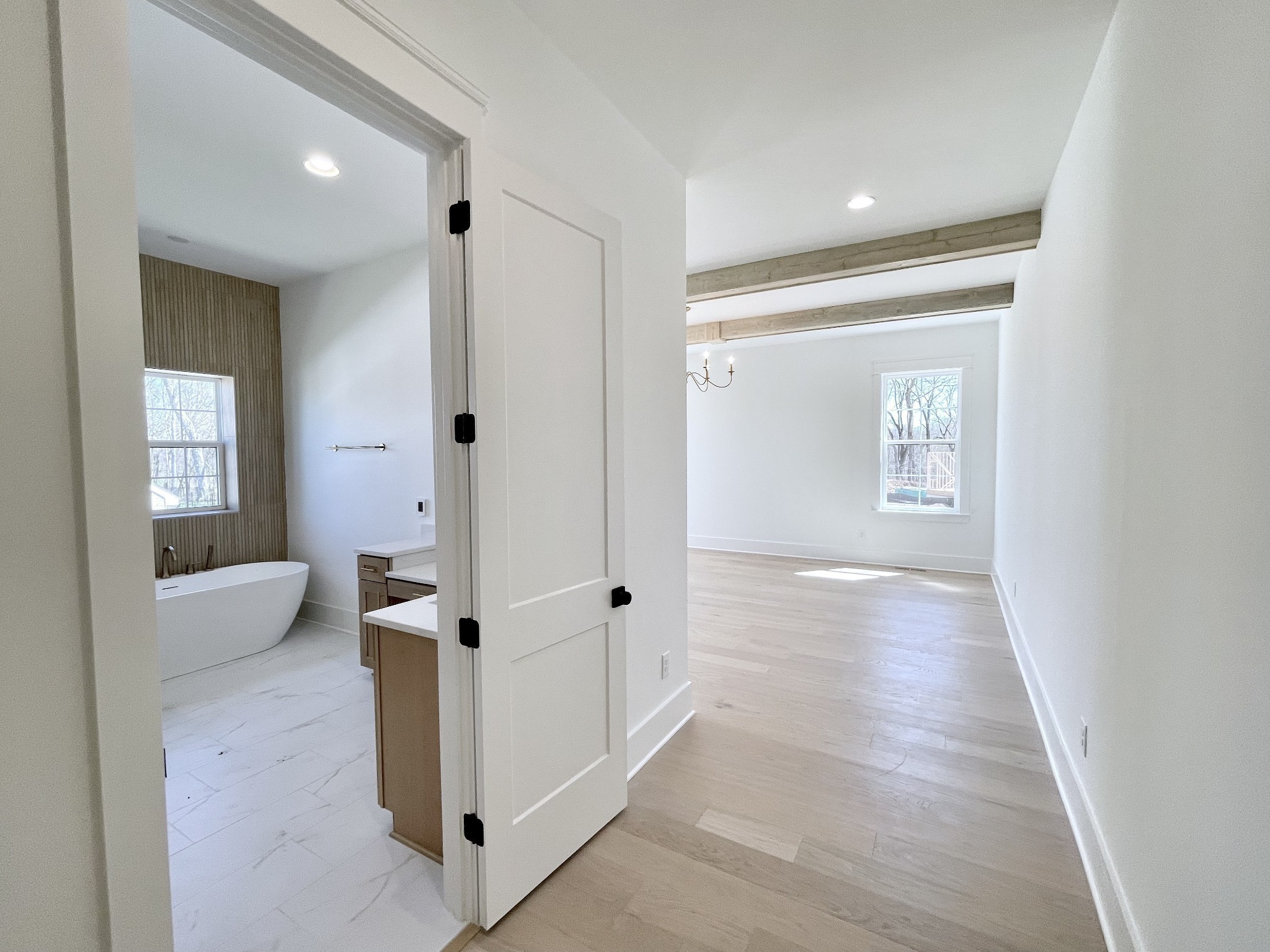 9917 Elland Road Brentwood, TN 37027 - Photo 65 of 99 a view of a hallway with bathroom and wooden floor