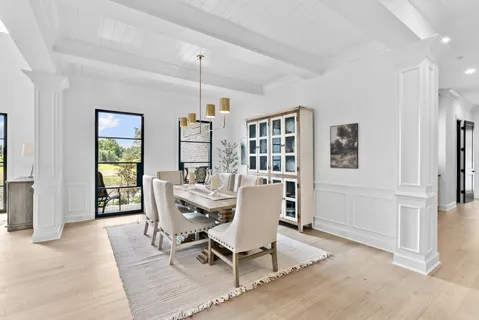 a kitchen with stainless steel appliances granite countertop a sink a stove and a wooden floors