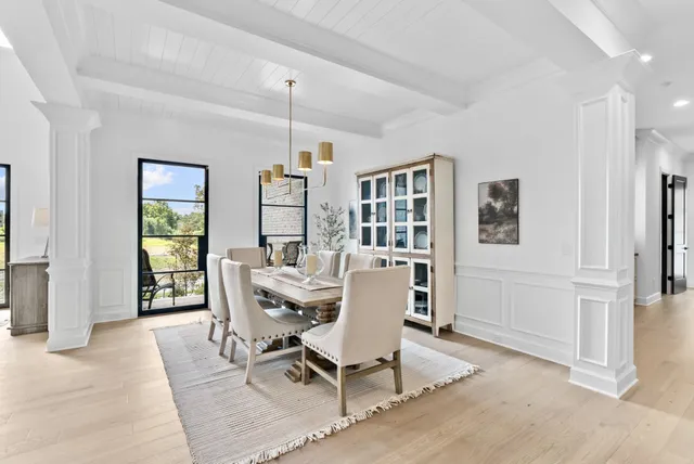 a view of an empty room with a fireplace and windows