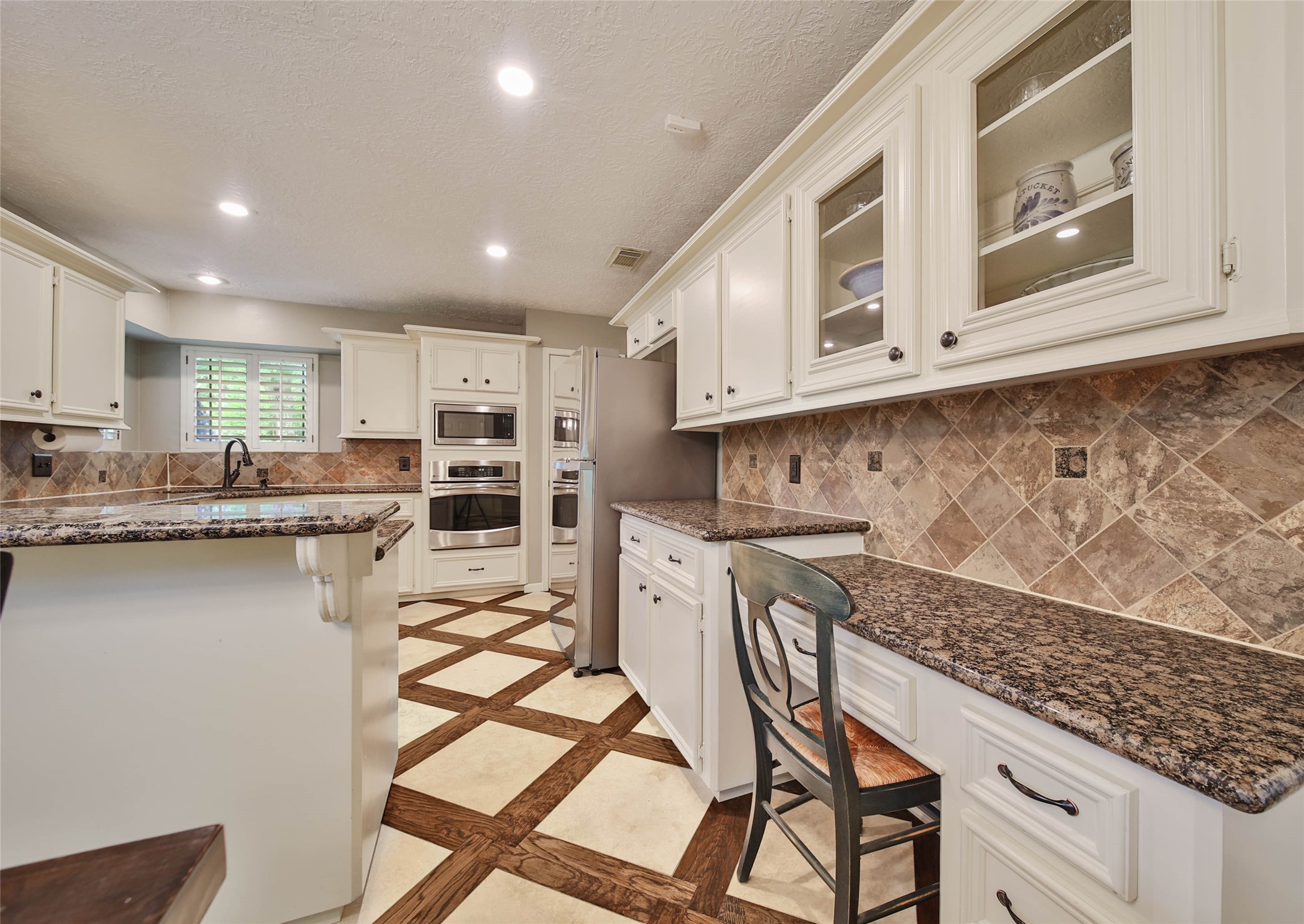 17007 Windrow Drive Spring, TX 77379 - Photo 13 of 46 a kitchen with granite countertop white cabinets and appliances