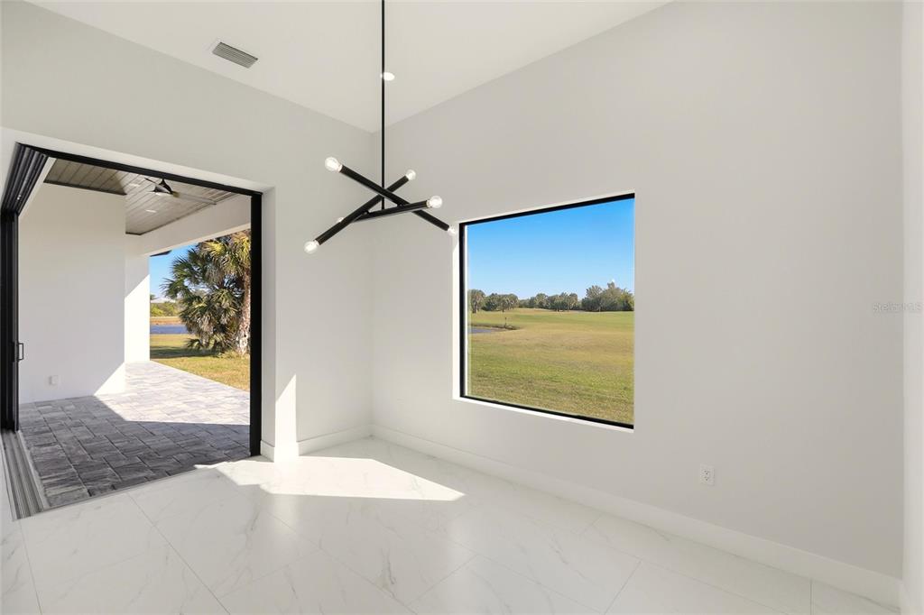 17 Long Meadow Road Rotonda West, FL 33947 - Photo 18 of 37 a view of empty room with wooden floor and fan