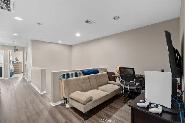 a living room with furniture and wooden floor