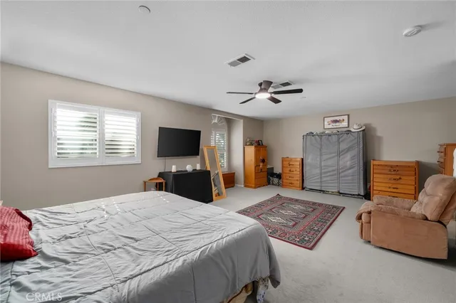 a bedroom with a large bed and a flat screen tv