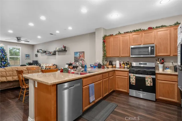 a kitchen with a sink appliances and cabinets