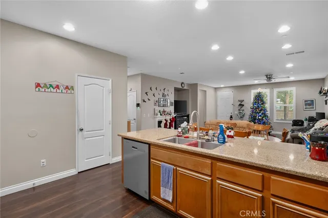 a view of a kitchen with kitchen island a sink wooden floor and glass door