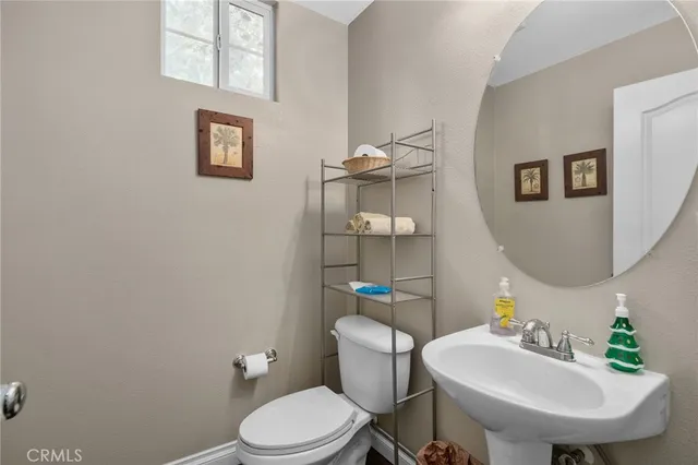 a bathroom with a sink mirror and toilet