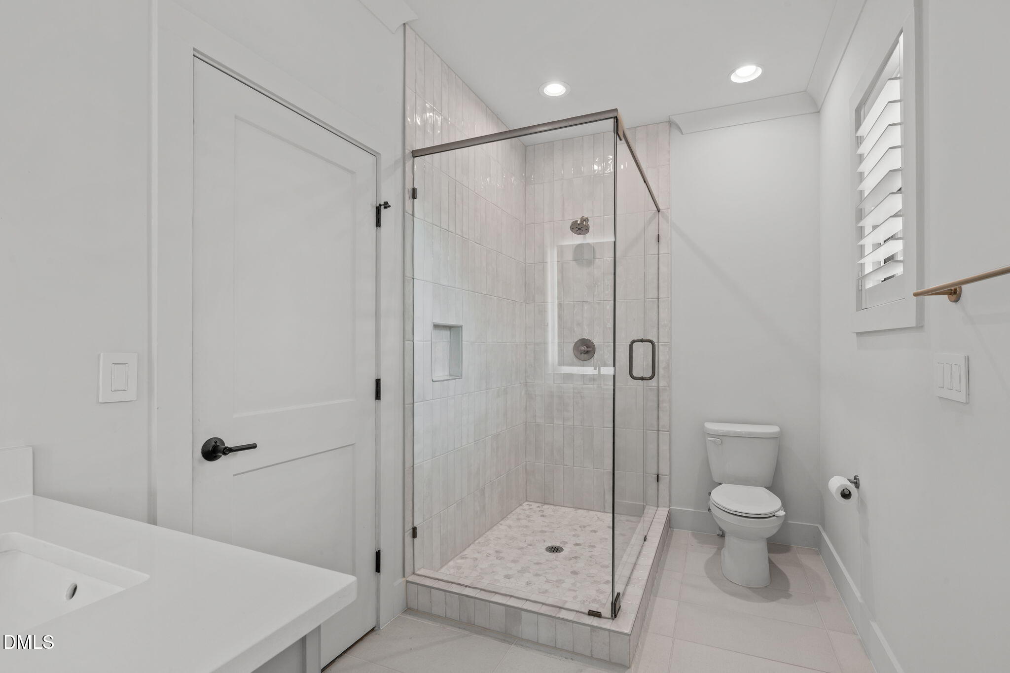 5005 Ten-Ten Road Apex, NC 27539 - Photo 31 of 60 Glass and tile shower, window for natural light. Door to loft area.