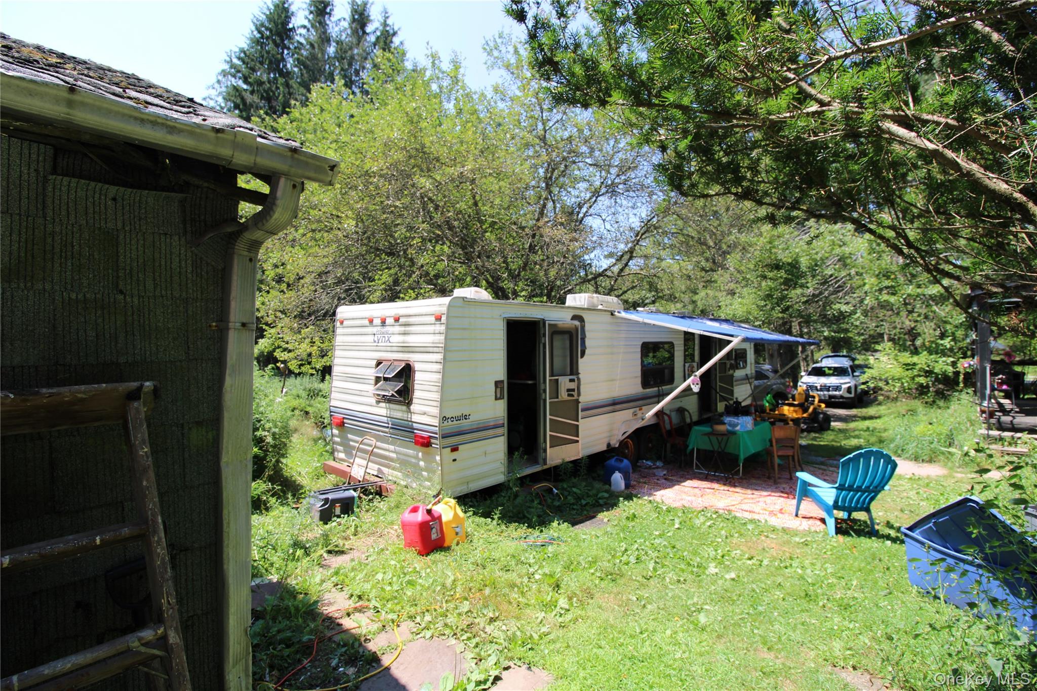 834 Cooley Road Parksville, NY 12768 - Photo 12 of 28 a view of backyard with a table and a chairs