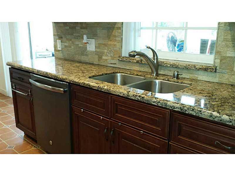 Sandalfoot Cove Boca Raton, FL 33428 - Photo 2 of 4 a bathroom with a sink a mirror and vanity