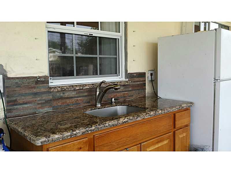 Sandalfoot Cove Boca Raton, FL 33428 - Photo 3 of 4 a kitchen with sink and refrigerator