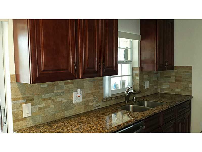 Sandalfoot Cove Boca Raton, FL 33428 - Photo 4 of 4 a kitchen with a sink and cabinets