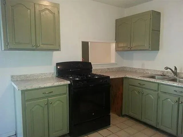 a kitchen with granite countertop cabinets and sink
