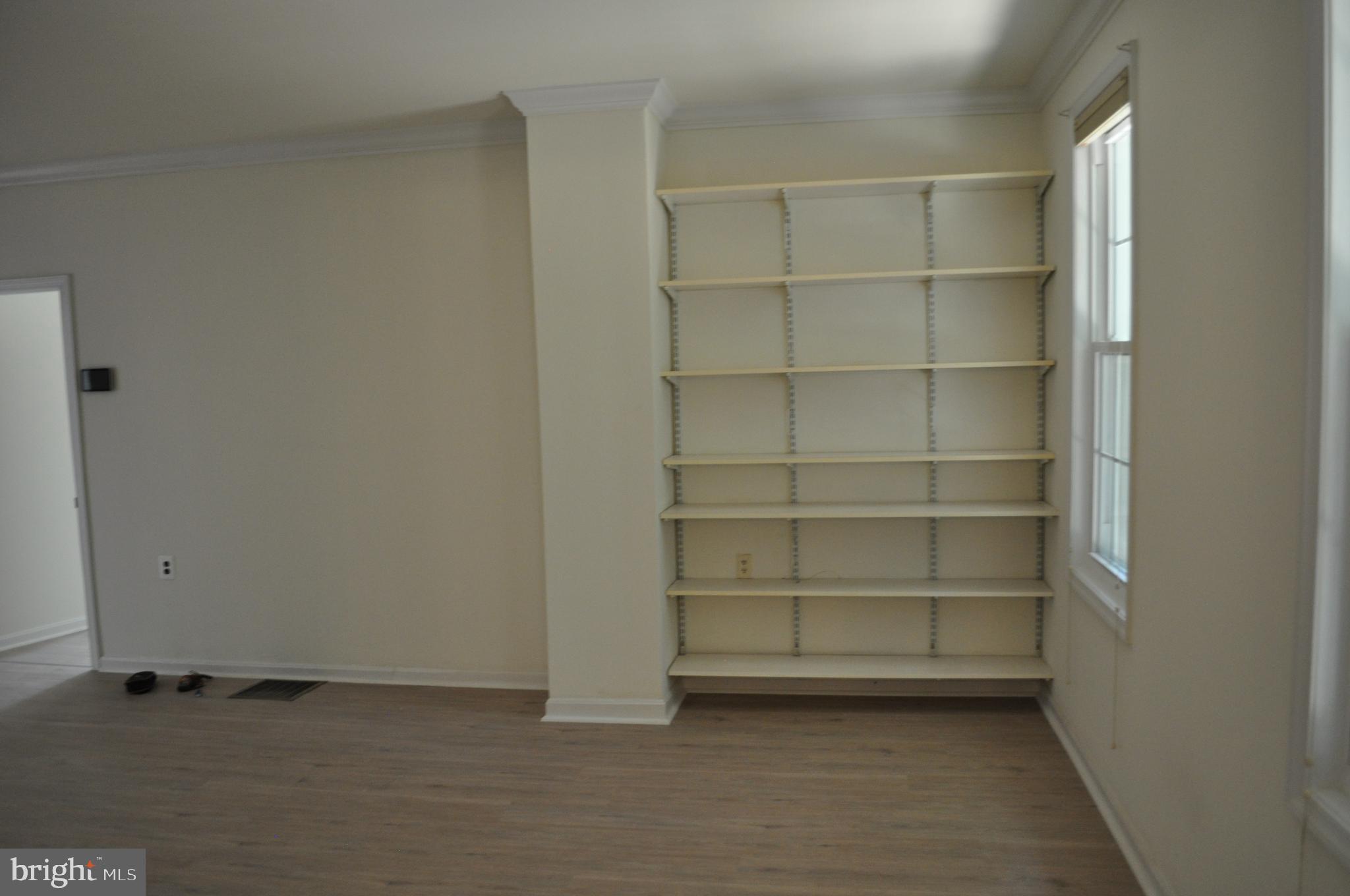 4302 Locust Lane Bethesda, MD 20816 - Photo 12 of 25 a view of an empty room with empty racks