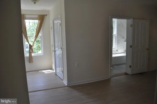an empty room with windows and closet