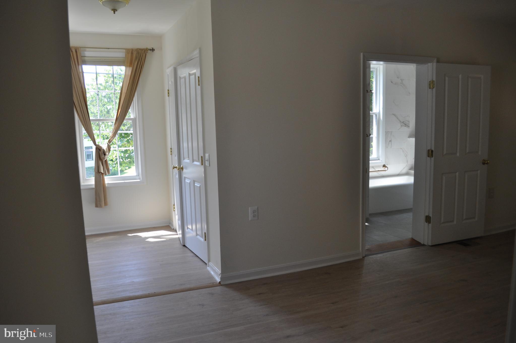 4302 Locust Lane Bethesda, MD 20816 - Photo 13 of 25 an empty room with windows and closet