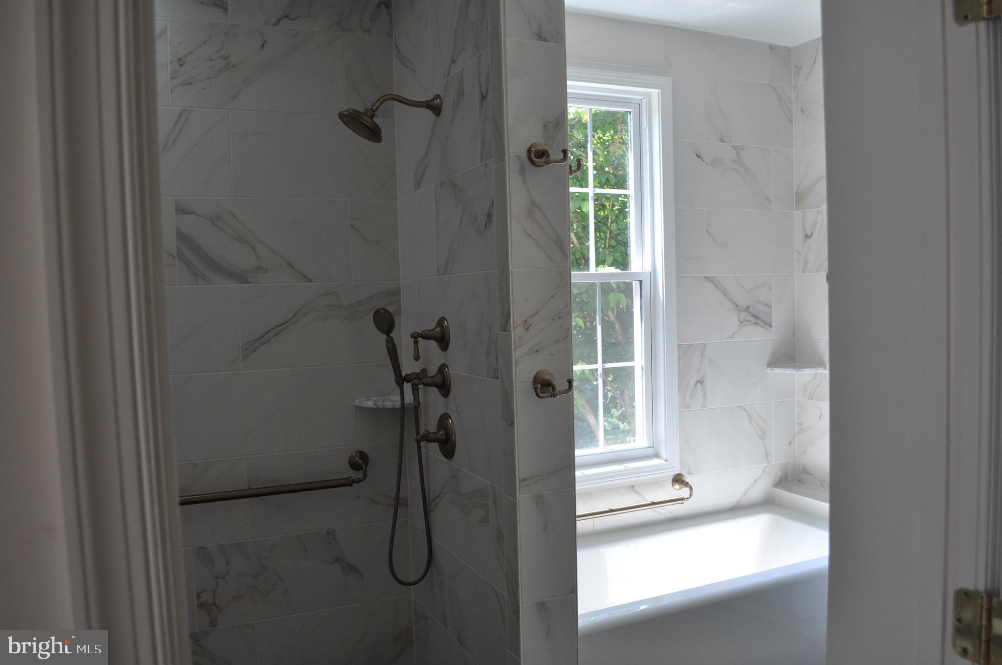4302 Locust Lane Bethesda, MD 20816 - Photo 15 of 25 a bathroom with a glass shower door