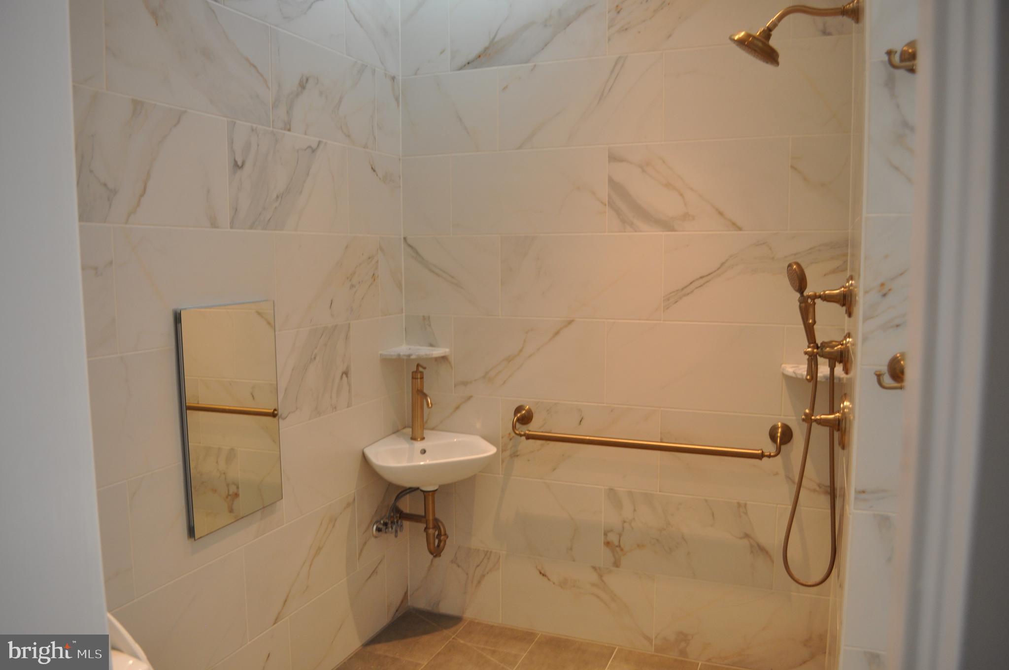 4302 Locust Lane Bethesda, MD 20816 - Photo 16 of 25 a bathroom with a sink toilet and shower