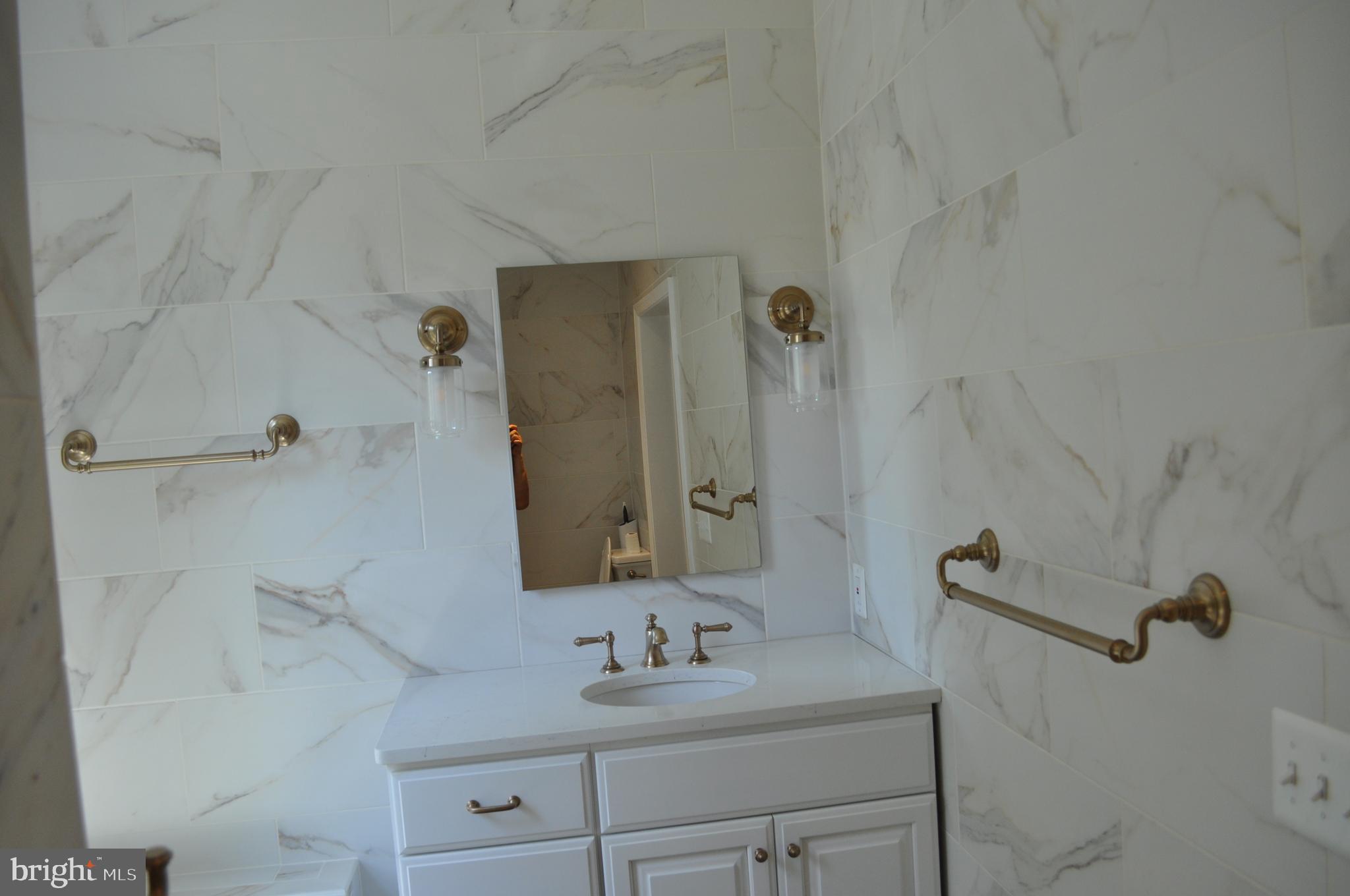 4302 Locust Lane Bethesda, MD 20816 - Photo 17 of 25 a bathroom with a sink and a mirror