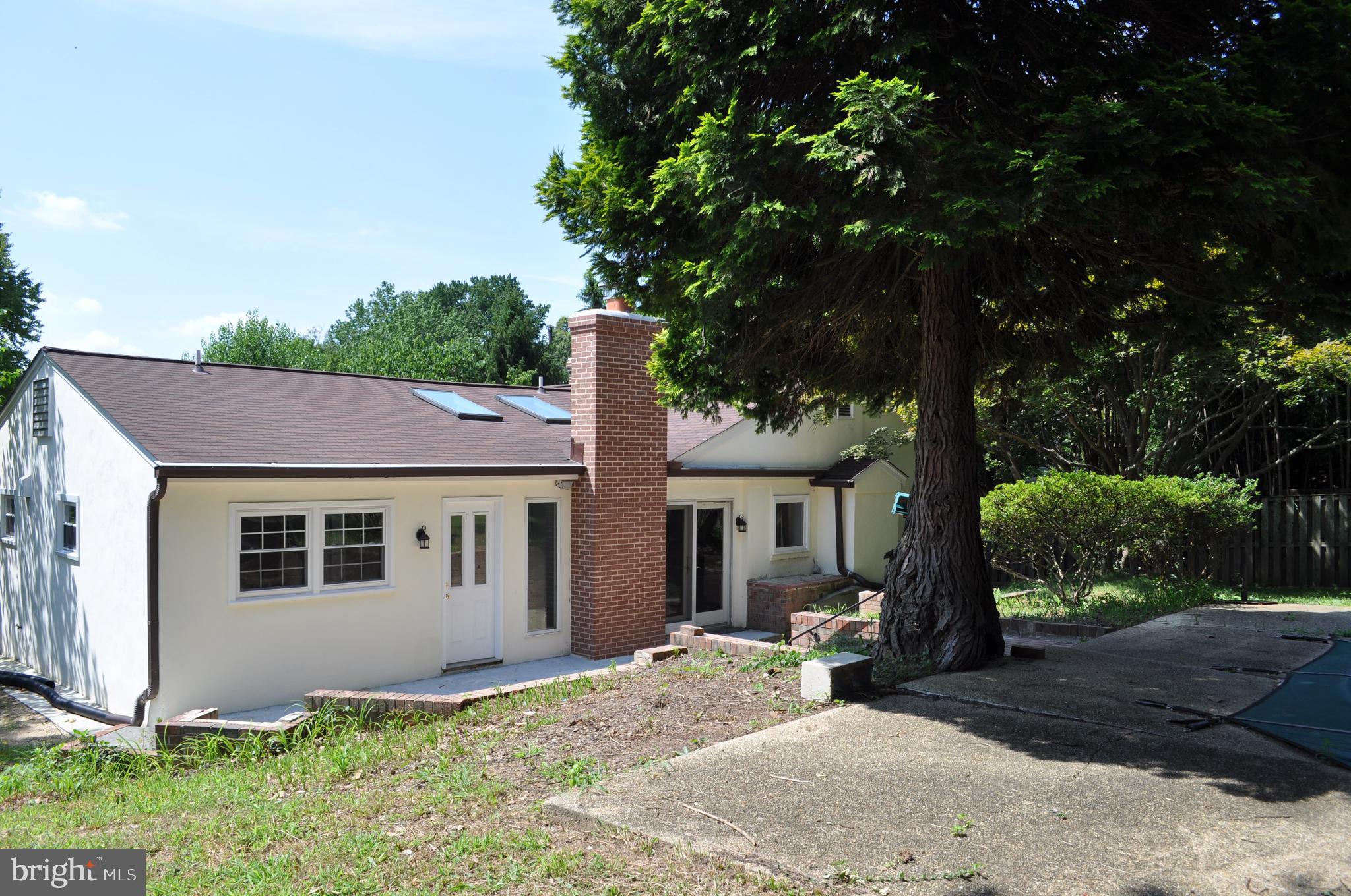 4302 Locust Lane Bethesda, MD 20816 - Photo 2 of 25 a house with a tree in front of it