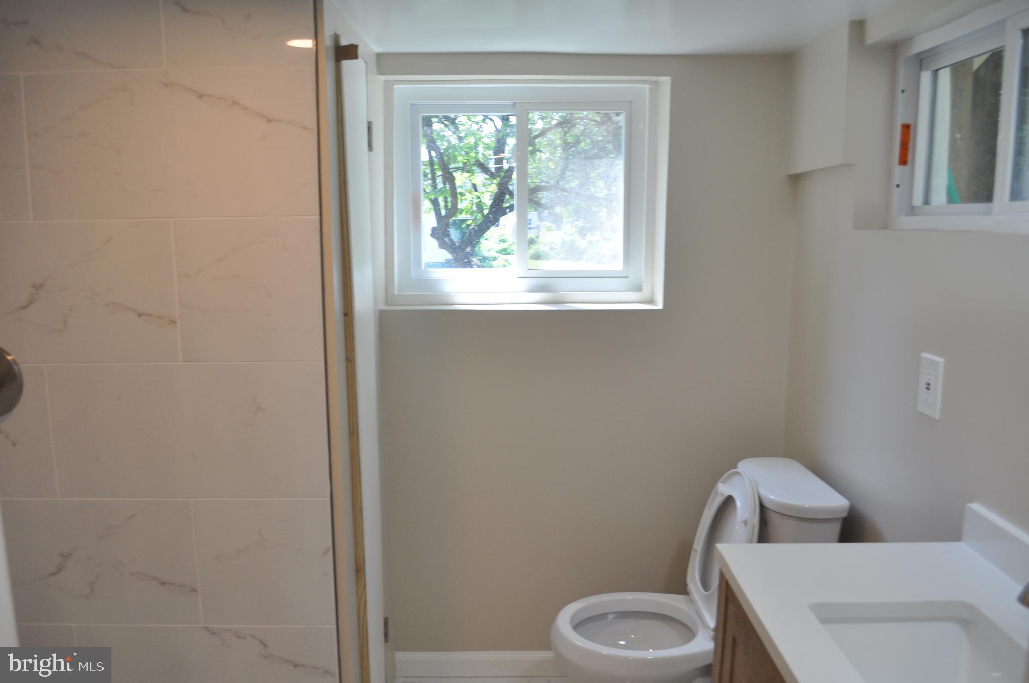 4302 Locust Lane Bethesda, MD 20816 - Photo 25 of 25 a white toilet sitting next to a bathroom sink