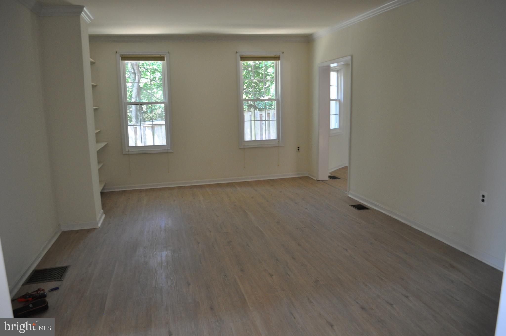 4302 Locust Lane Bethesda, MD 20816 - Photo 6 of 25 an empty room with wooden floor and windows
