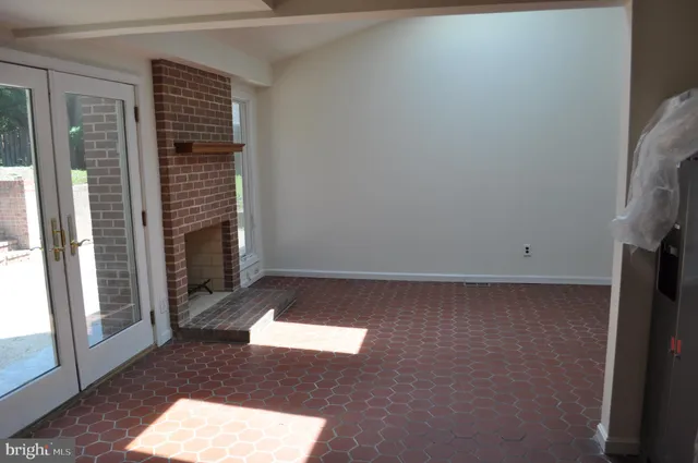 a view of an empty room with a fireplace