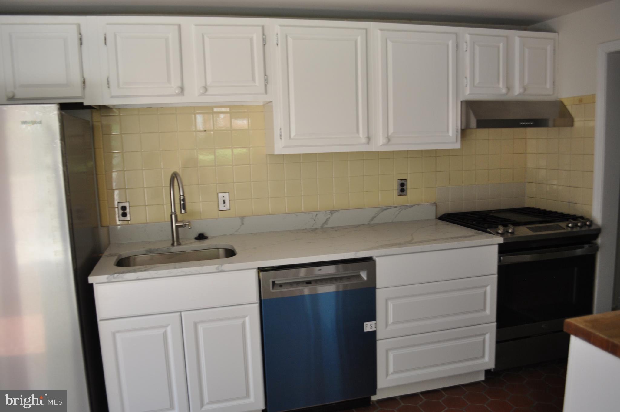 4302 Locust Lane Bethesda, MD 20816 - Photo 10 of 25 a kitchen with a sink and cabinets