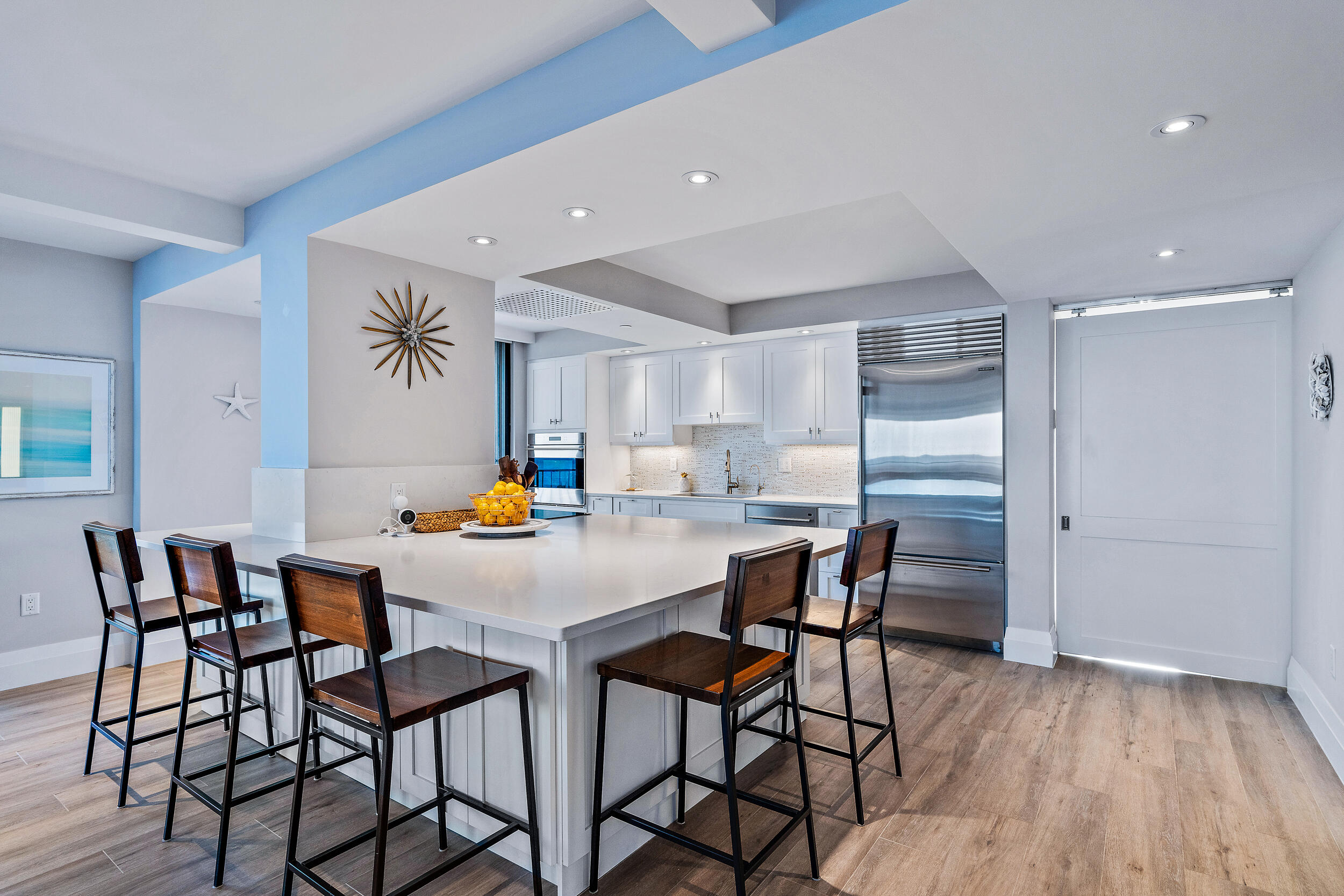 100 South Beach Road, Unit 604 Tequesta, FL 33469 - Photo 11 of 58 a kitchen with stainless steel appliances a table chairs and a refrigerator