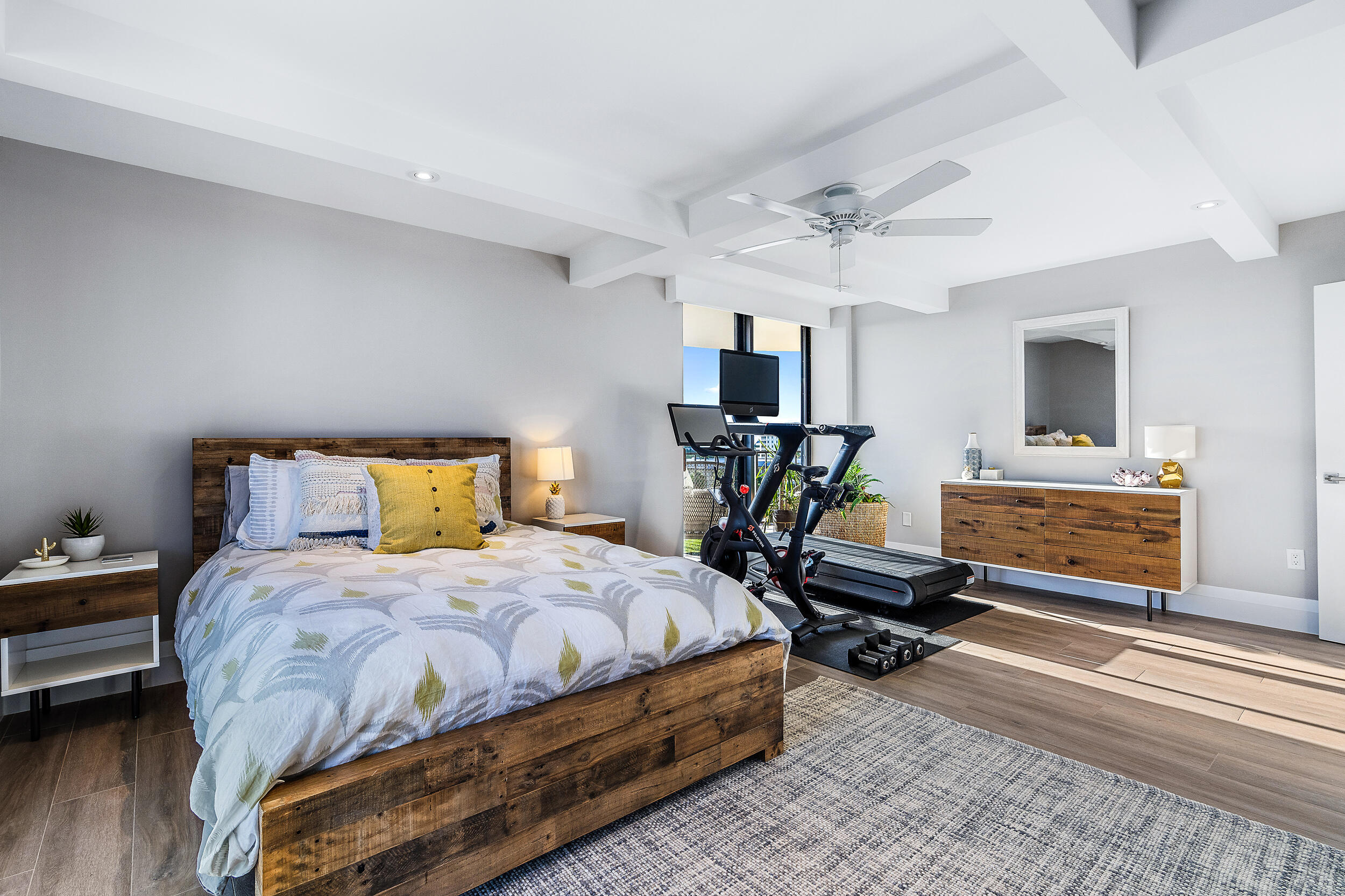 100 South Beach Road, Unit 604 Tequesta, FL 33469 - Photo 32 of 58 a bedroom with a bed a chandelier and flat screen tv