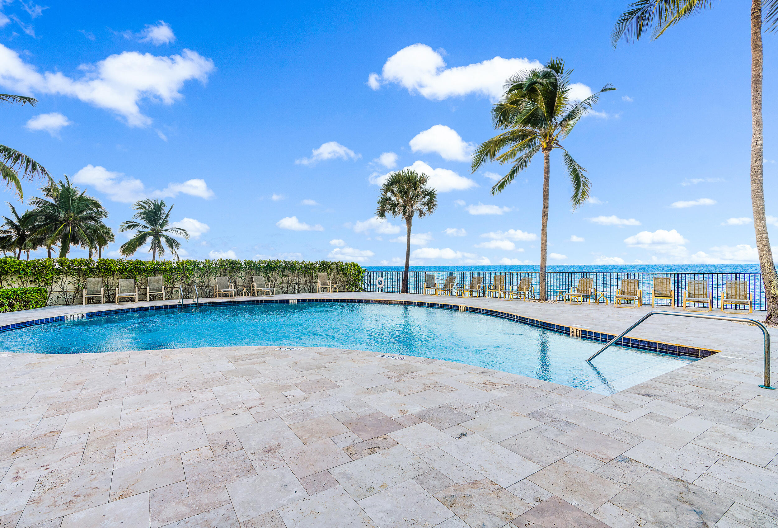 100 South Beach Road, Unit 604 Tequesta, FL 33469 - Photo 41 of 58 a view of a swimming pool with a chair and tables