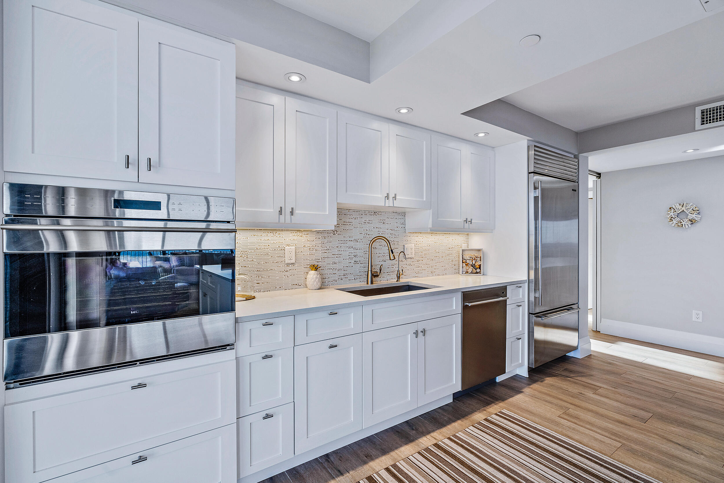 100 South Beach Road, Unit 604 Tequesta, FL 33469 - Photo 9 of 58 a kitchen with white cabinets and sink