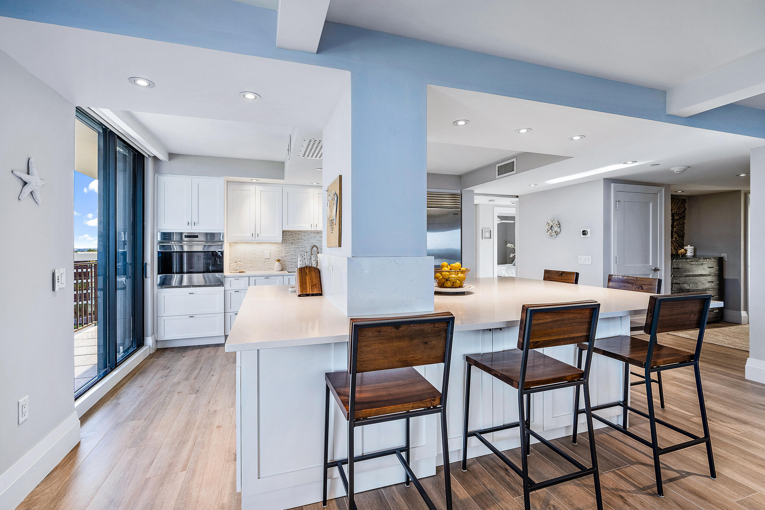 100 South Beach Road, Unit 604 Tequesta, FL 33469 - Photo 10 of 58 a kitchen with stainless steel appliances kitchen island granite countertop a dining table chairs and a refrigerator