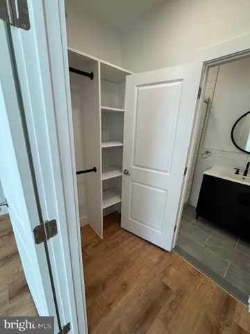 a bathroom with a toilet sink a mirror and vanity