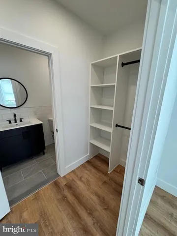 a bathroom with a sink a mirror and a shower