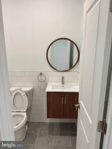 a white toilet and tub sitting next to a bathroom sink