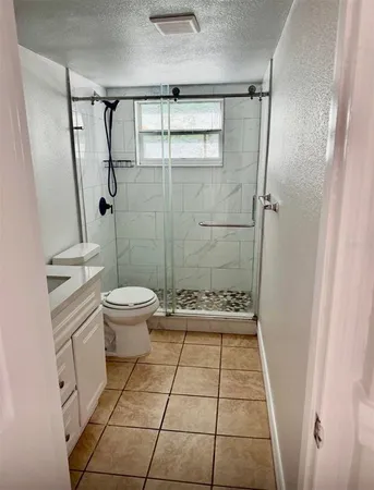 a bathroom with a toilet and a shower