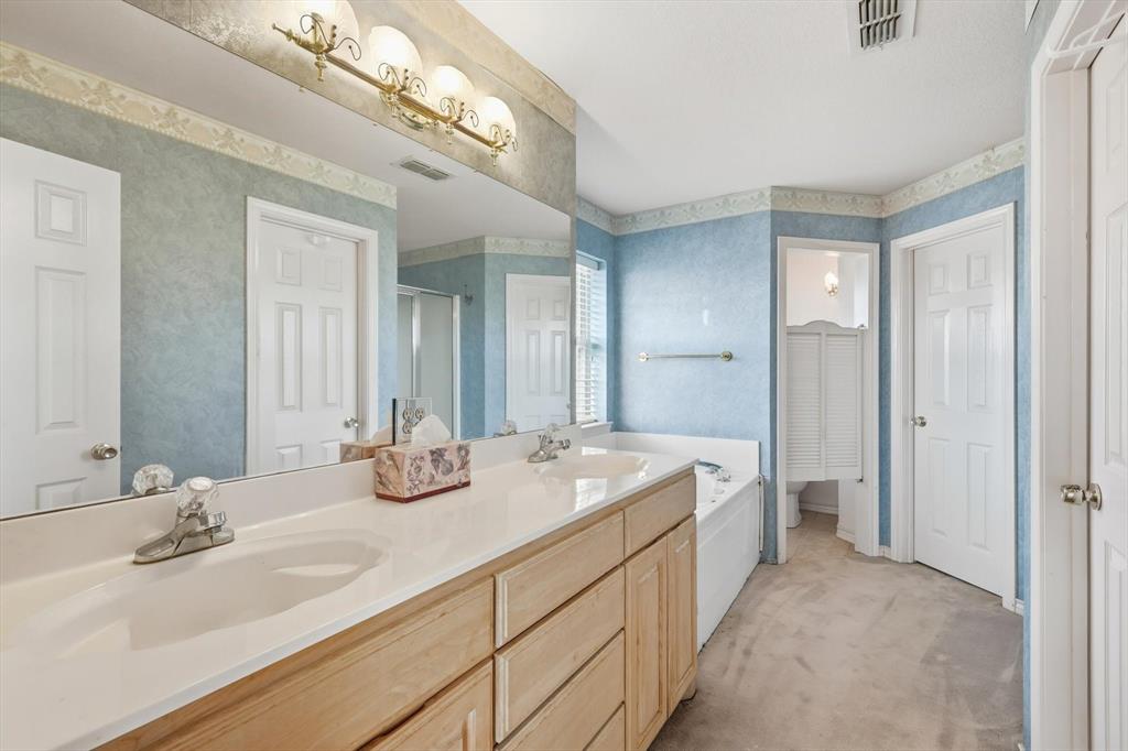 2296 Old Decatur Road Decatur, TX 76234 - Photo 20 of 39 Bathroom with light carpet, a shower stall, double vanity, wallpapered walls, and a bath
