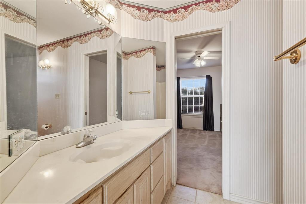 2296 Old Decatur Road Decatur, TX 76234 - Photo 26 of 39 Bathroom featuring light colored carpet, vanity, light tile patterned flooring, and ceiling fan