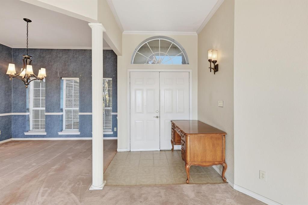 2296 Old Decatur Road Decatur, TX 76234 - Photo 4 of 39 Entryway with ornamental molding, light tile patterned floors, a chandelier, light colored carpet, and ornate columns