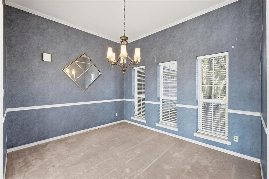 2296 Old Decatur Road Decatur, TX 76234 - Photo 5 of 39 Spare room featuring crown molding, carpet floors, and a chandelier