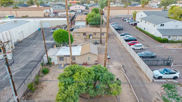 a aerial view of a house with plants and large trees