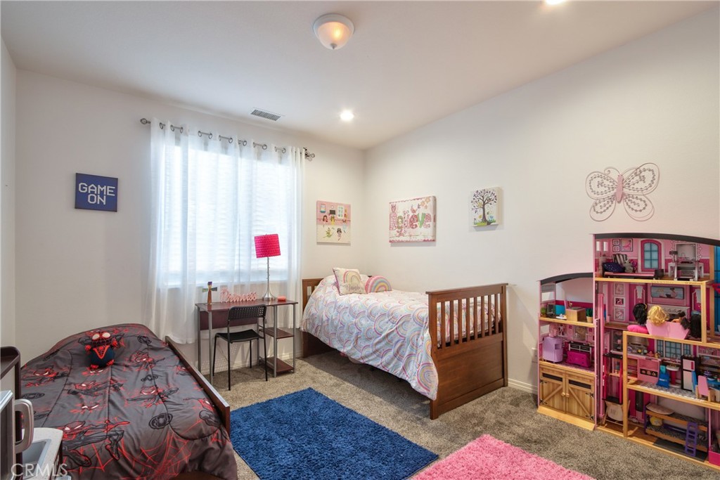 28483 Nautical Point Circle Menifee, CA 92585 - Photo 24 of 44 a bedroom with furniture and a book shelf