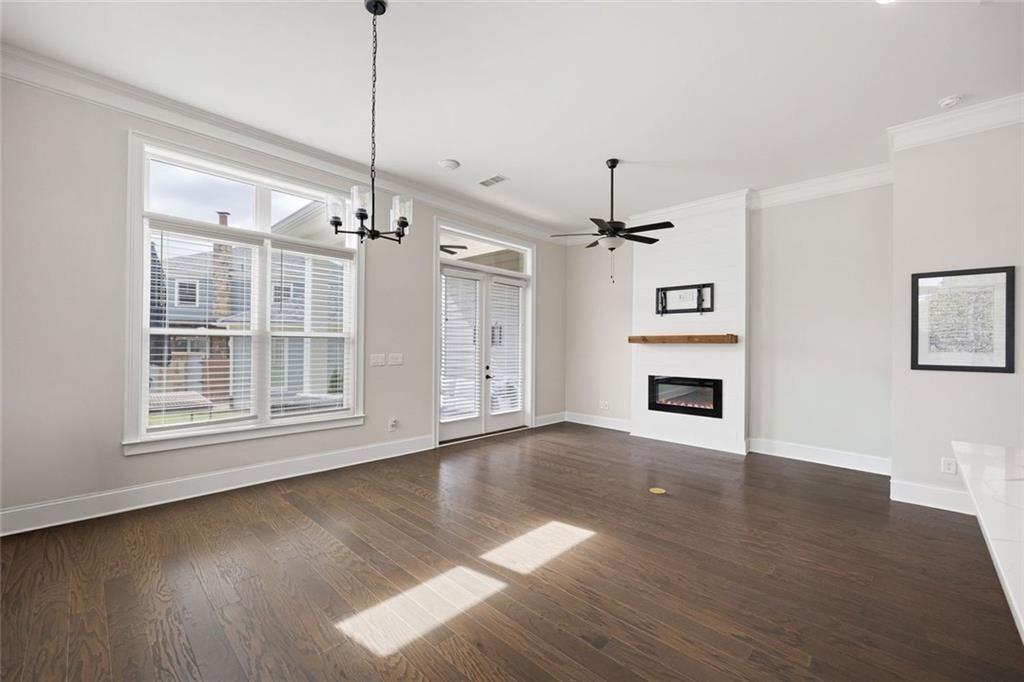 109 Village Green Avenue Woodstock, GA 30189 - Photo 14 of 37 a view of a kitchen with wooden floor and a ceiling fan