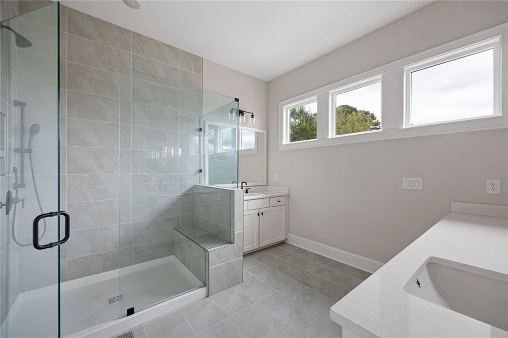 109 Village Green Avenue Woodstock, GA 30189 - Photo 20 of 37 a bathroom with a tub sink and mirror