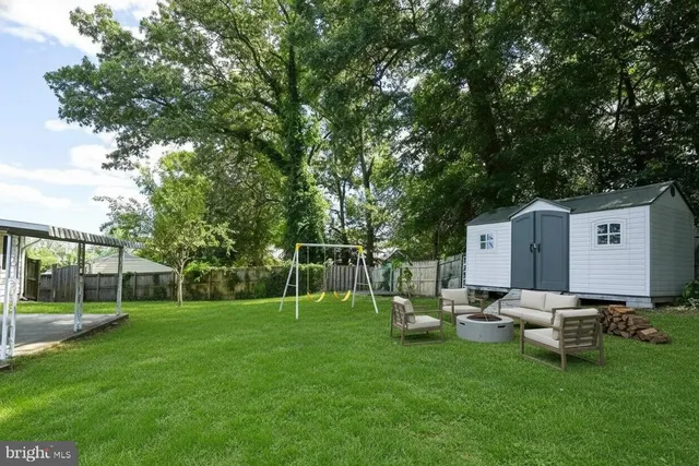 a view of a chair and tables in the back yard