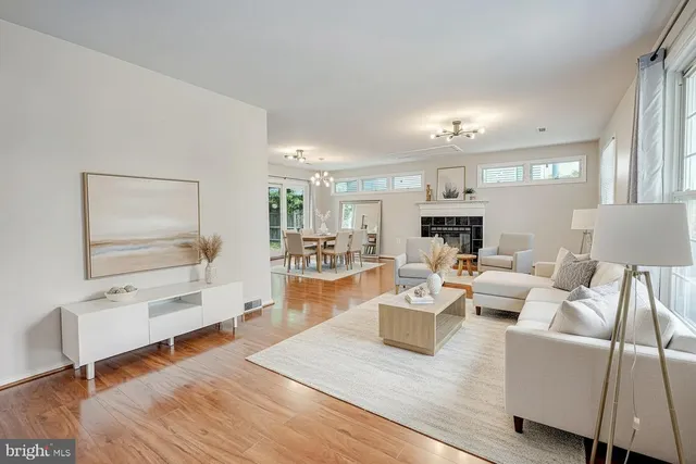 a living room with fireplace furniture and a wooden floor
