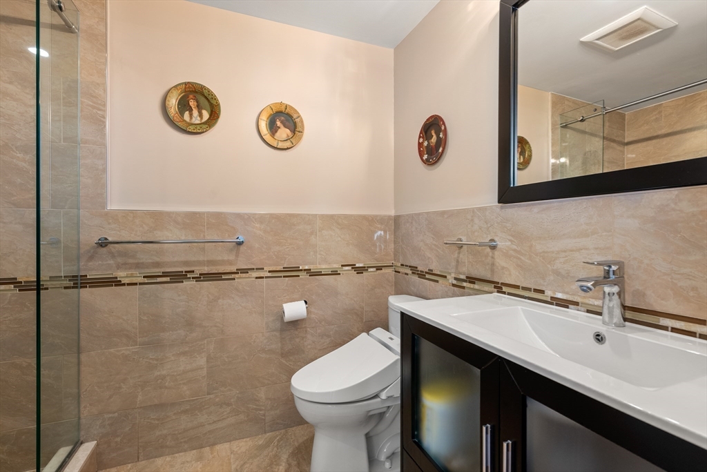 79 Florence Street, Unit 508S Newton, MA 02467 - Photo 11 of 20 a bathroom with a sink mirror vanity and toilet