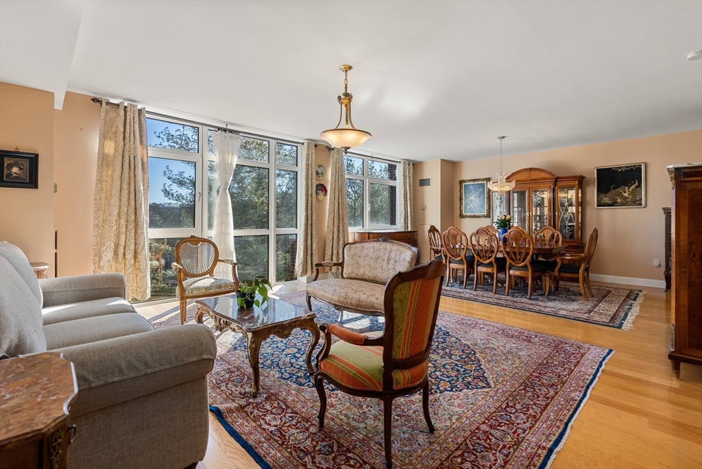 79 Florence Street, Unit 508S Newton, MA 02467 - Photo 2 of 20 a living room with furniture dining table and a fireplace